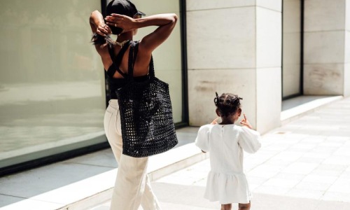 a woman walking with her child