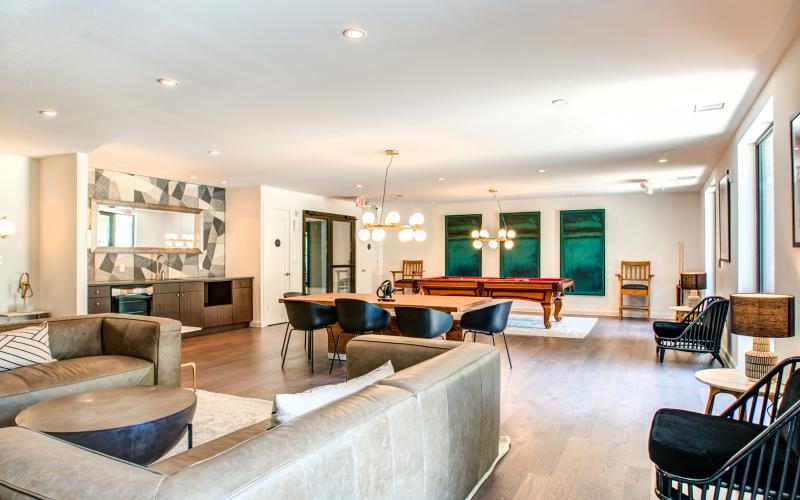 a large room with a large bar and chairs