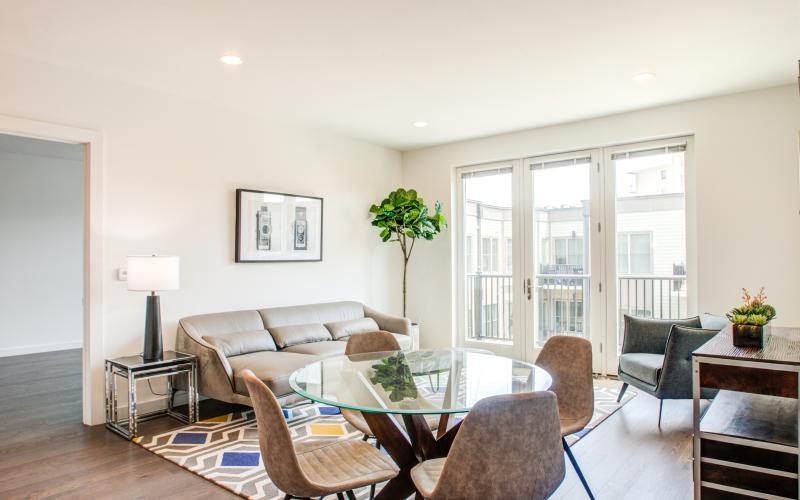 a living room with a large glass table and chairs